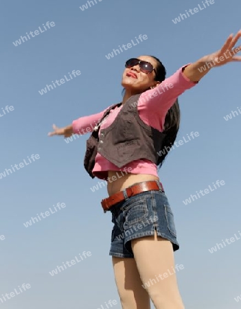 young jumping woman with blue background