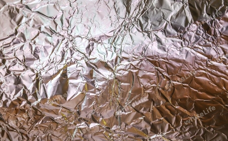 Detailed close up texture of an aluminum foil surface in different colors