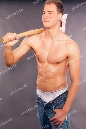 Sexy muskul?ser junger Mann beim hacken von Brennholz
