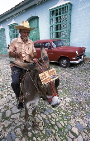 a  men in the old Town of the Village of trinidad on Cuba in the caribbean sea.