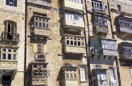 The traditional Balconys on the Houses in the Old Town of the city of Valletta on the Island of Malta in the Mediterranean Sea in Europe.
