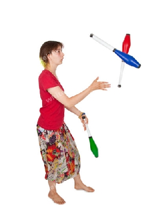 Junge Frau beim Jonglieren auf hellem Hintergrund