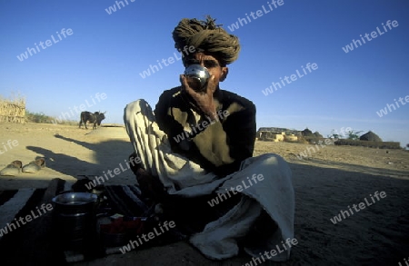 a men drinks water in the deset of tar near the town of Barmer in the province Rajasthan in India.
