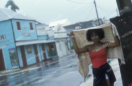 people go shoping bevor a tropical storm in the town of  St Gilles les Bains  on the Island of La Reunion in the Indian Ocean in Africa.
