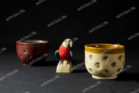 Wooden parrot and ceramic mug