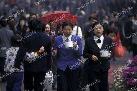 People with tea at the main square in the city of Chongqing in the province of Sichuan in china in east asia. 