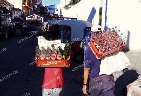 people with coca cola bottles in the old town in the city of Antigua in Guatemala in central America.   