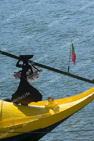 a tourist boat of the port wine company Porto cruz on the Douro River in Ribeira in the city centre of Porto in Porugal in Europe.