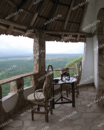 detail of the Kingfisher Lodge in Uganda (Africa) with roofed patio, chairs and table