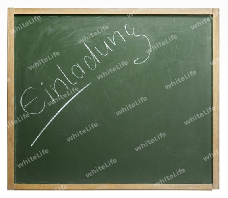 old used blackboard with written "Einladung" on it. Studio photography in white back