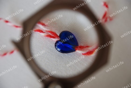 Blue heart under magnifying glass