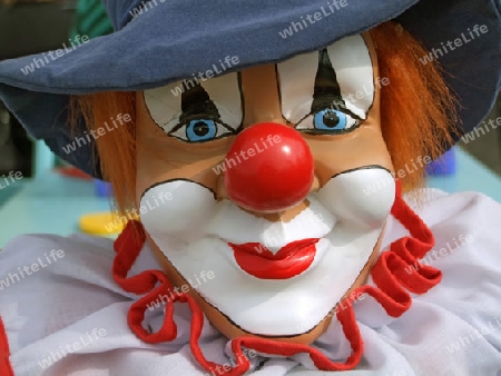 Portrait from a colorful clown doll as backround