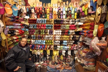 a shop in the Marketroad in the Medina of old City in the historical Town of Fes in Morocco in north Africa.