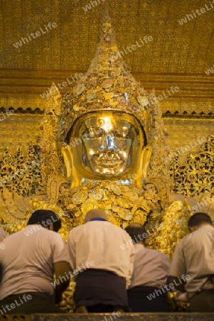 The Mahamuni Buddha at the Mahamuni temple in the City of Mandalay in Myanmar in Southeastasia.