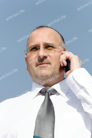 serious businessman with black cellphone
