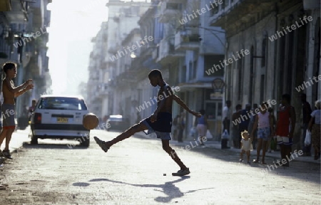 people play soccer in the old town of the city Havana on Cuba in the caribbean sea.