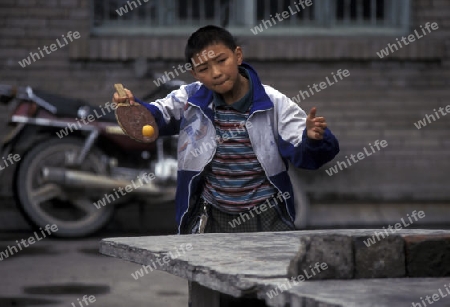 cilder play table tennis in the city of wushan on the yangzee river near the three gorges valley up of the three gorges dam project in the province of hubei in china.