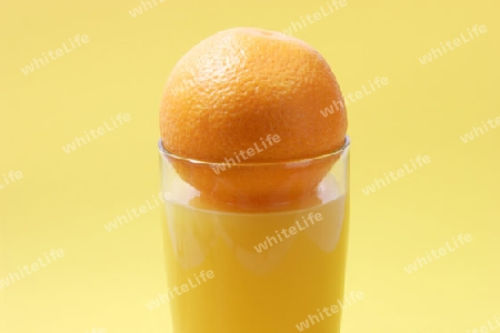 Orangensaft mit Glas auf hellem Hintergrund