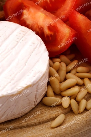 Cheese, pine nuts and tomato