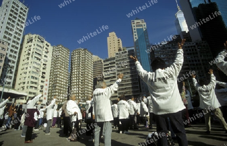 People making Tai chi in central Hong Kong in the south of China in Asia.