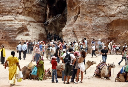 Tourists in the Bab as Siq valley in the Temple city of Petra in Jordan in the middle east.