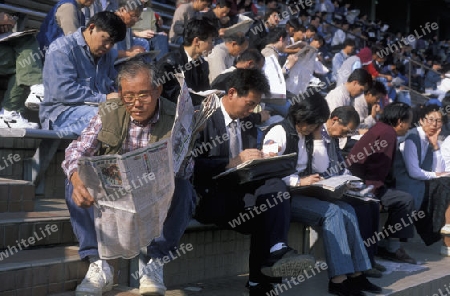 people play for money at the horserace in the City Centre of Hong Kong in the south of China in Asia.