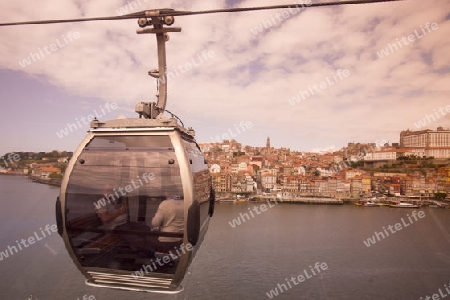 the cablecar and the old town on the Douro River in Ribeira in the city centre of Porto in Porugal in Europe.