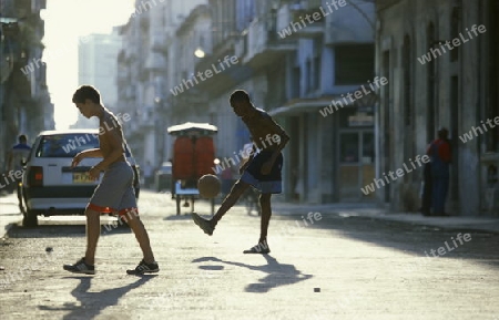 people play soccer in the old town of the city Havana on Cuba in the caribbean sea.