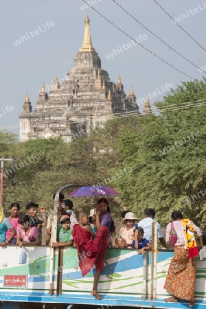 Myanmar Tourista on a Truckbus Taxi in front of a  Temple and Pagoda  in Bagan in Myanmar in Southeastasia.