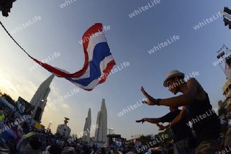 Thai anti-government protesters wave national flags during a rally at theDemocracy Monument in .Bangkok, Thailand, Saturday Jan.11 , 2014.