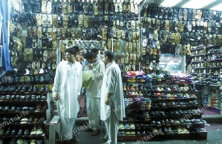 a shoe shop the souq or Market in the old town in the city of Dubai in the Arab Emirates in the Gulf of Arabia.