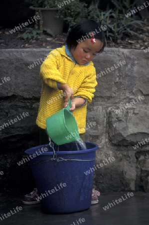 a girl get water at the main square in the city of Chongqing in the province of Sichuan in china in east asia. 