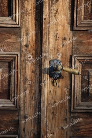 Old lock with chains on a wooden door
