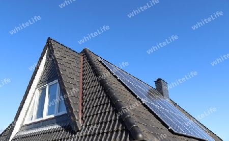 Solar panels producing clean energy on a roof of a residential house