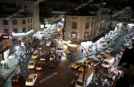 a road in the city centre at night in the City Amman in Jordan in the middle east.