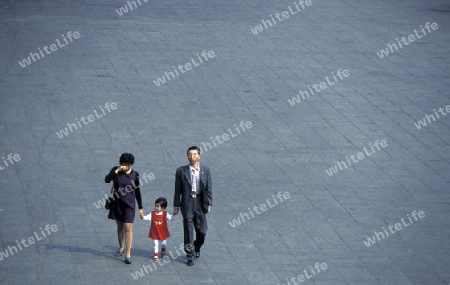 a family in the market street in the city of Shenzhen north of Hongkong in the province of Guangdong in china in east asia. 