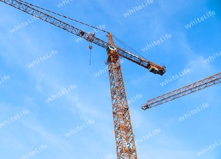 Several cranes on constructions sites at high buildings all over Europe.