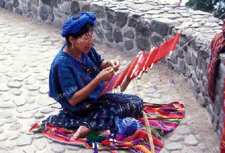 a women works in traditional clotes in the Village of  Panajachel in Guatemala in central America.   