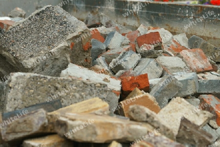 Steine von einem abgerissenen Haus in einem Bauschuttcontainer.
