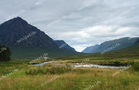 clouded scenery in Scotland around Rannoch Moor showing wide grassland and hills